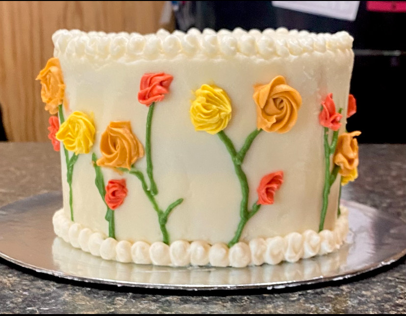 Elegant white custom flower cake from Cottage Sweets Baking Co.